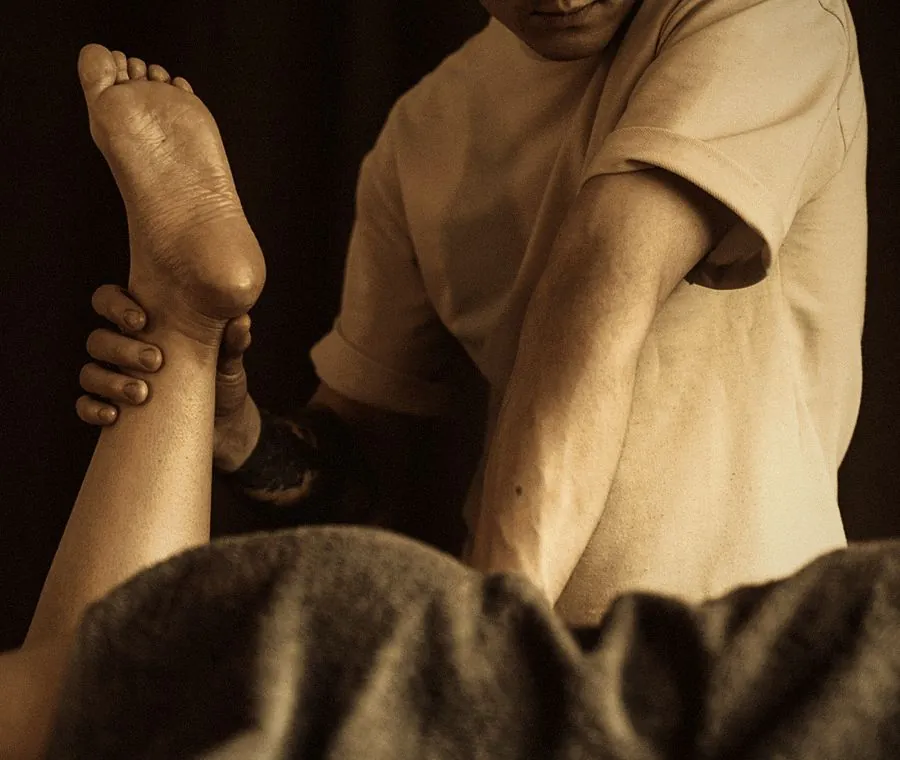 ACL rehab and mobility: a therapist stretching a client's raised leg