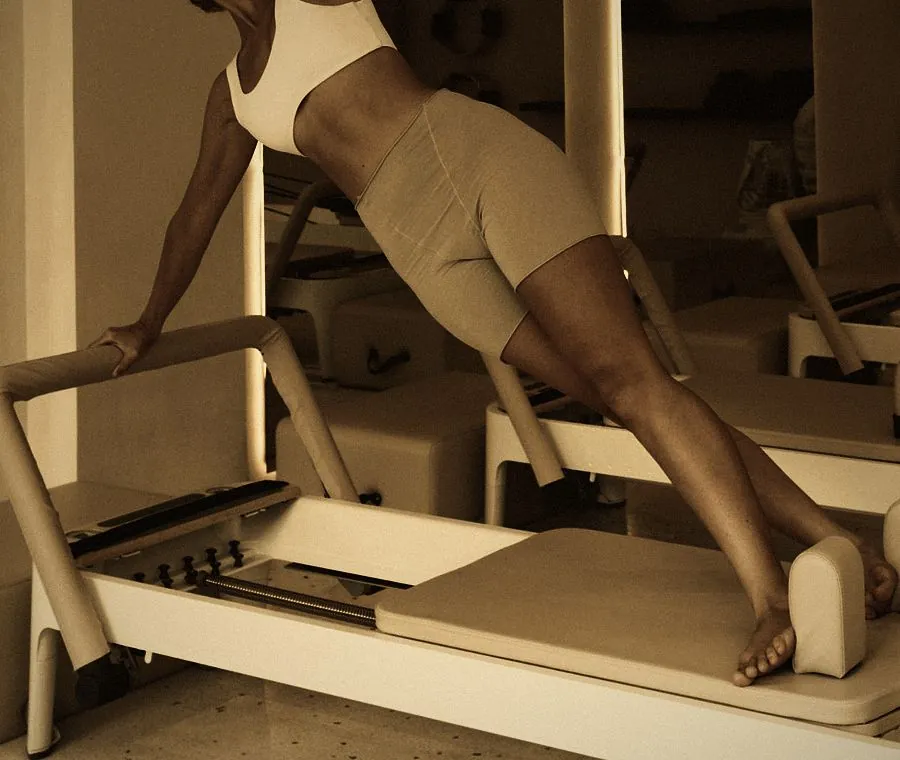 Pilates training in Dubai: a lunge on a Pilates reformer